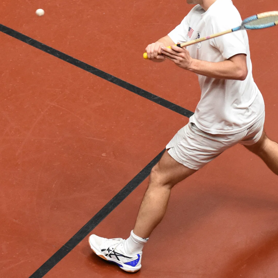 Player mid-shot on the rackets court